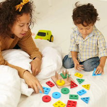 Load image into Gallery viewer, Toddler playing with a wooden four-peg shape sorter